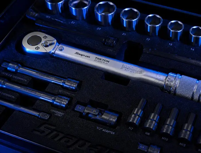 Calibrated torque wrench and professional sockets in a foam-lined tool case